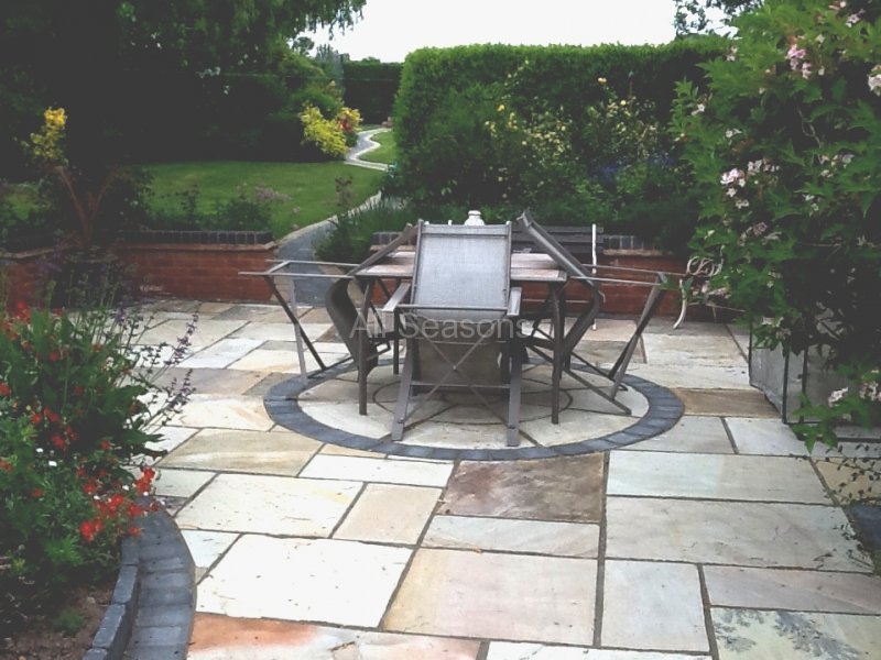 Sandstone dining patio with a circular paving feature